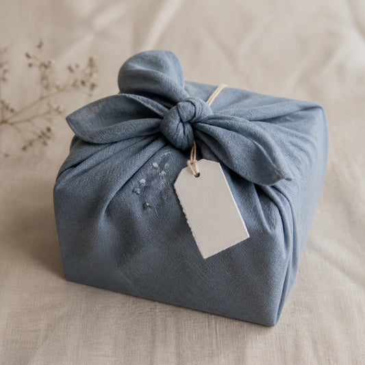 photo d'un cadeau emballé dans un tissu bleu
